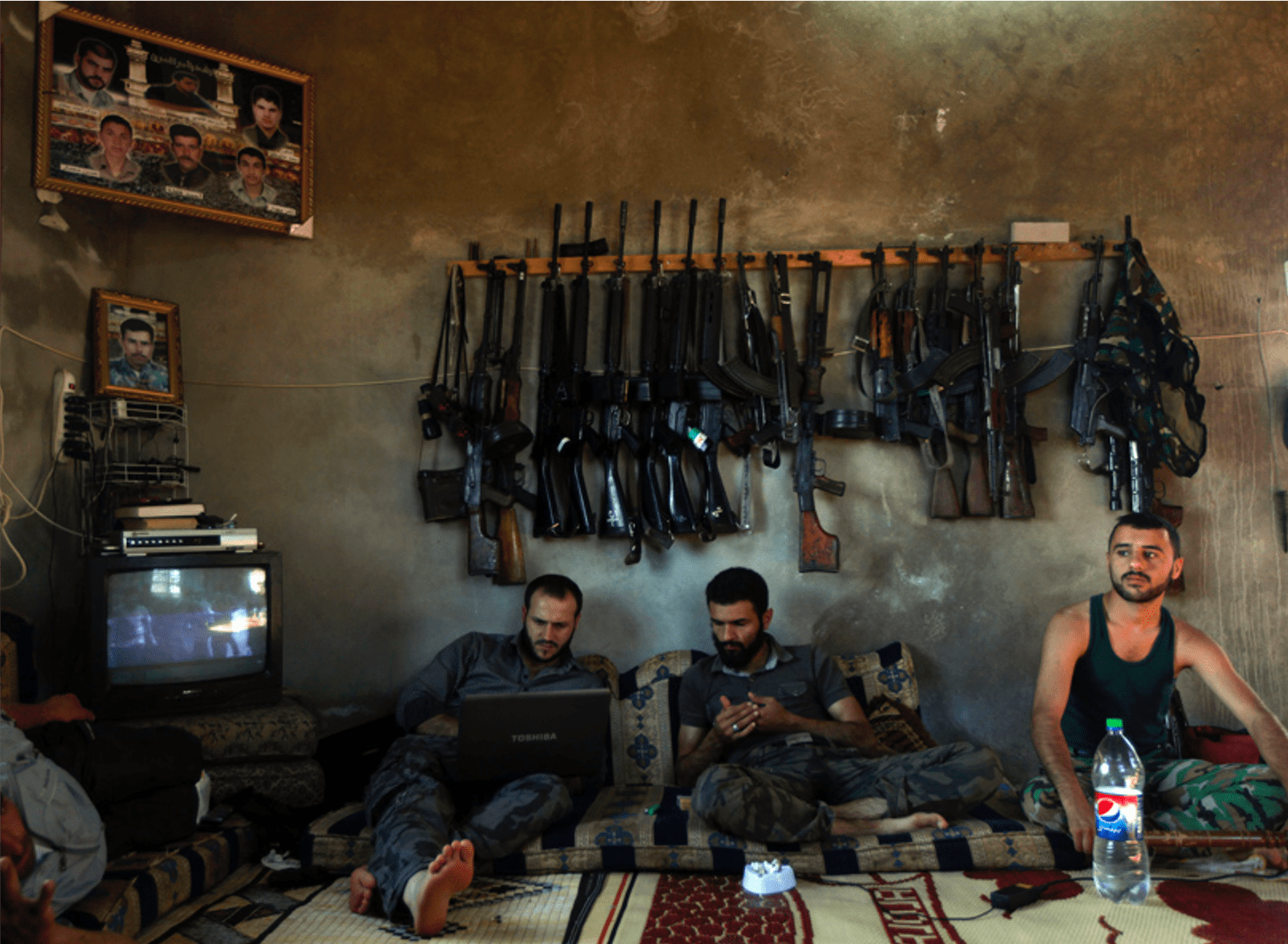 Pulitzer-Winning Photos: Free Syrian Army fighters sit in a house on the outskirts of Aleppo, Syria, June 12, 2012. (Khalil Hamra, Associated Press - June 12, 2012)