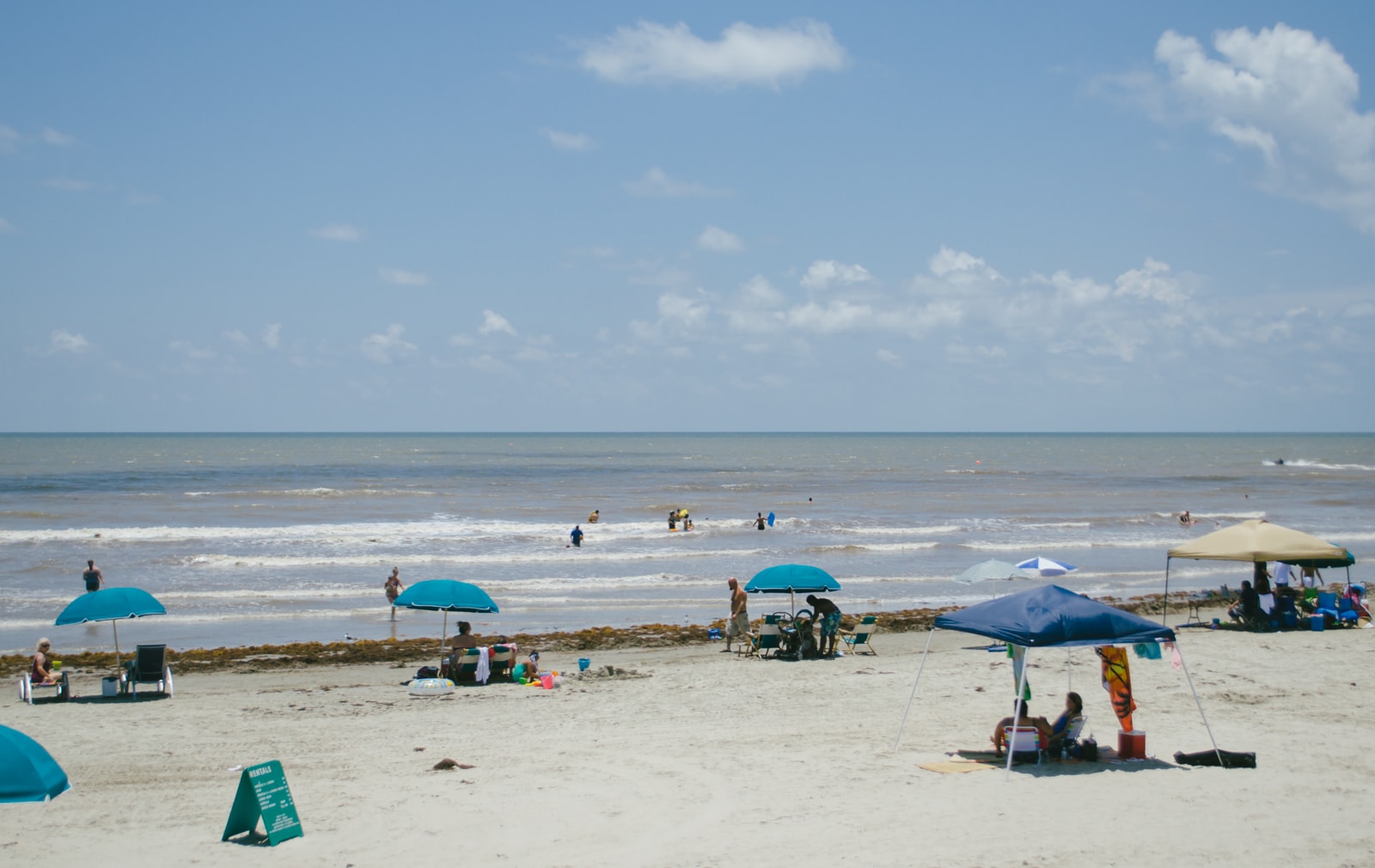 People enjoying a day at the beach in Galveston