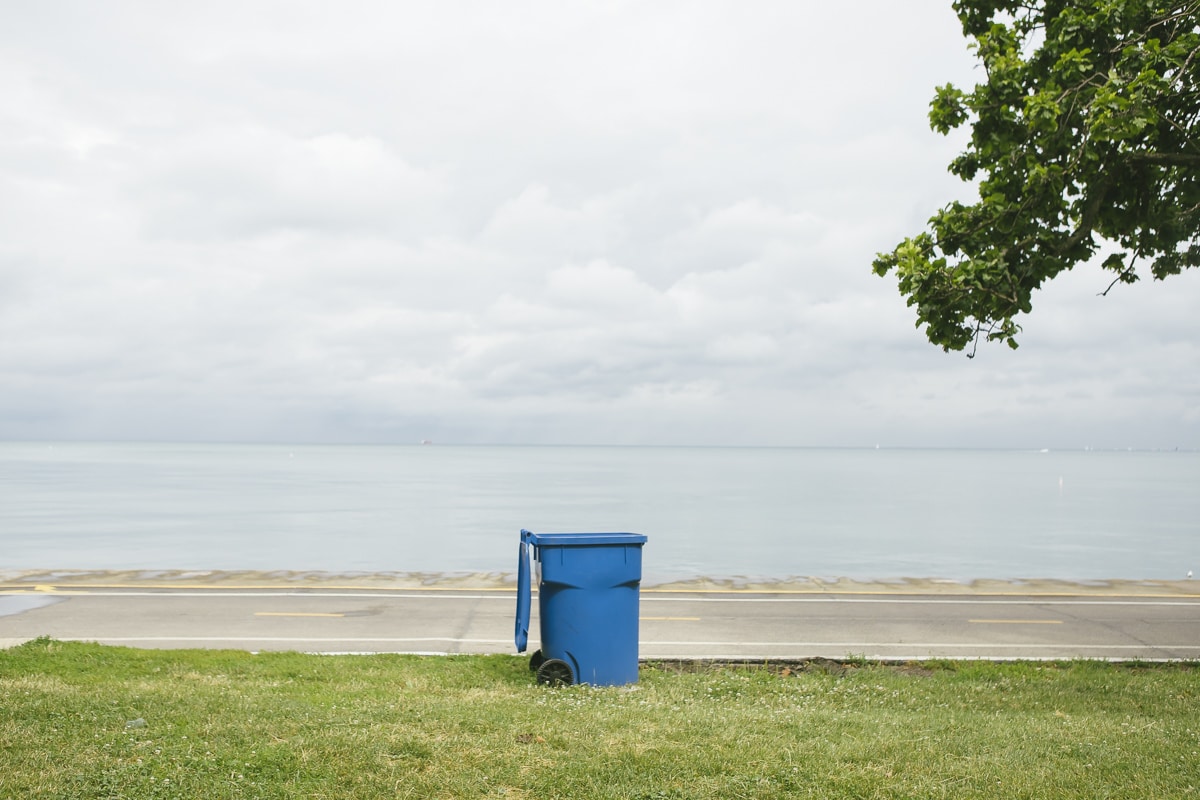 A blue trash can by Lake Michigan