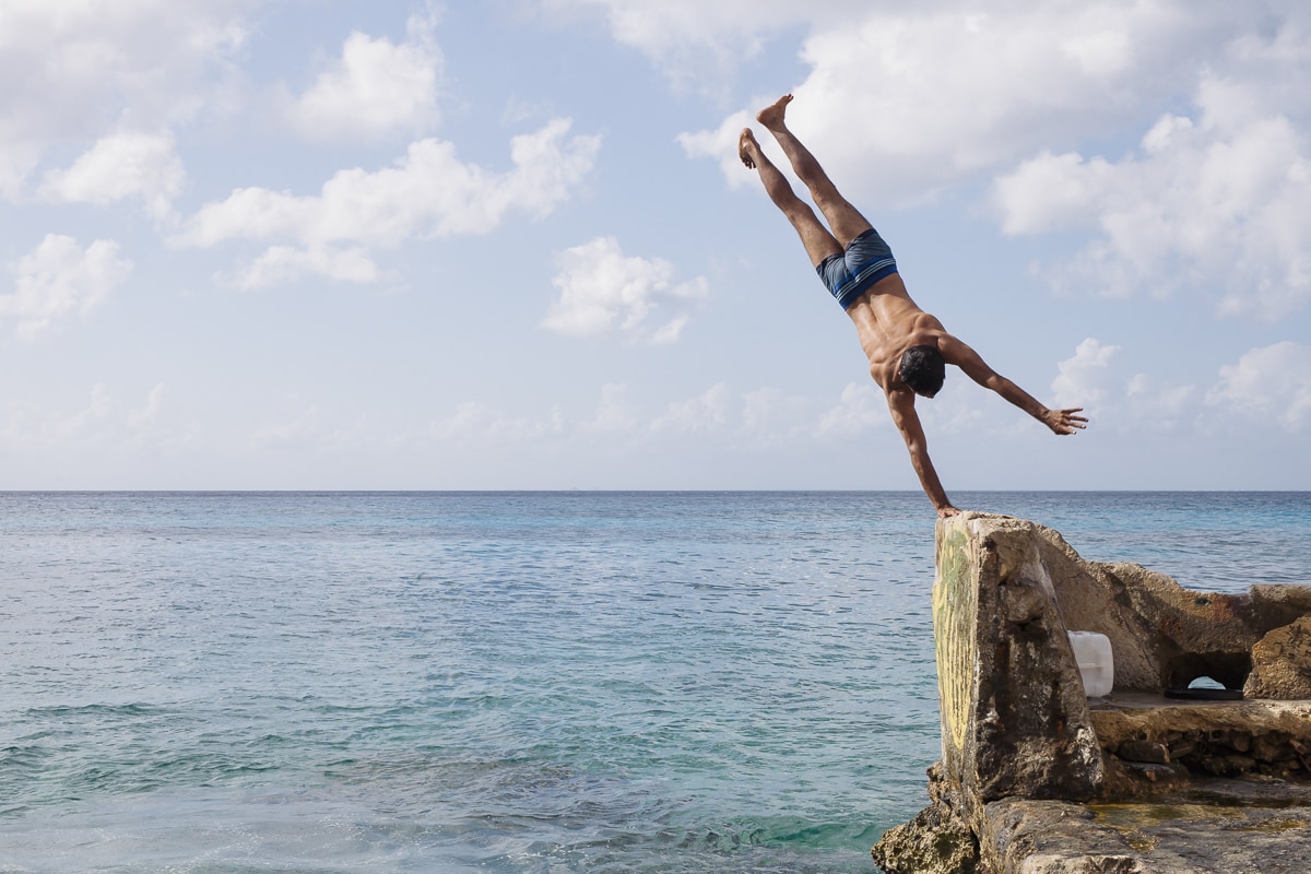 A guy doing a hand stand in Cozumel