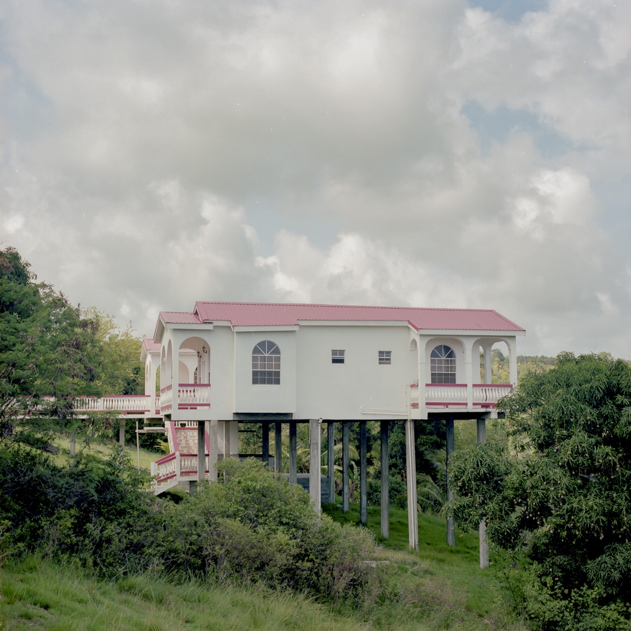 A house on stilts built on the side of a hill