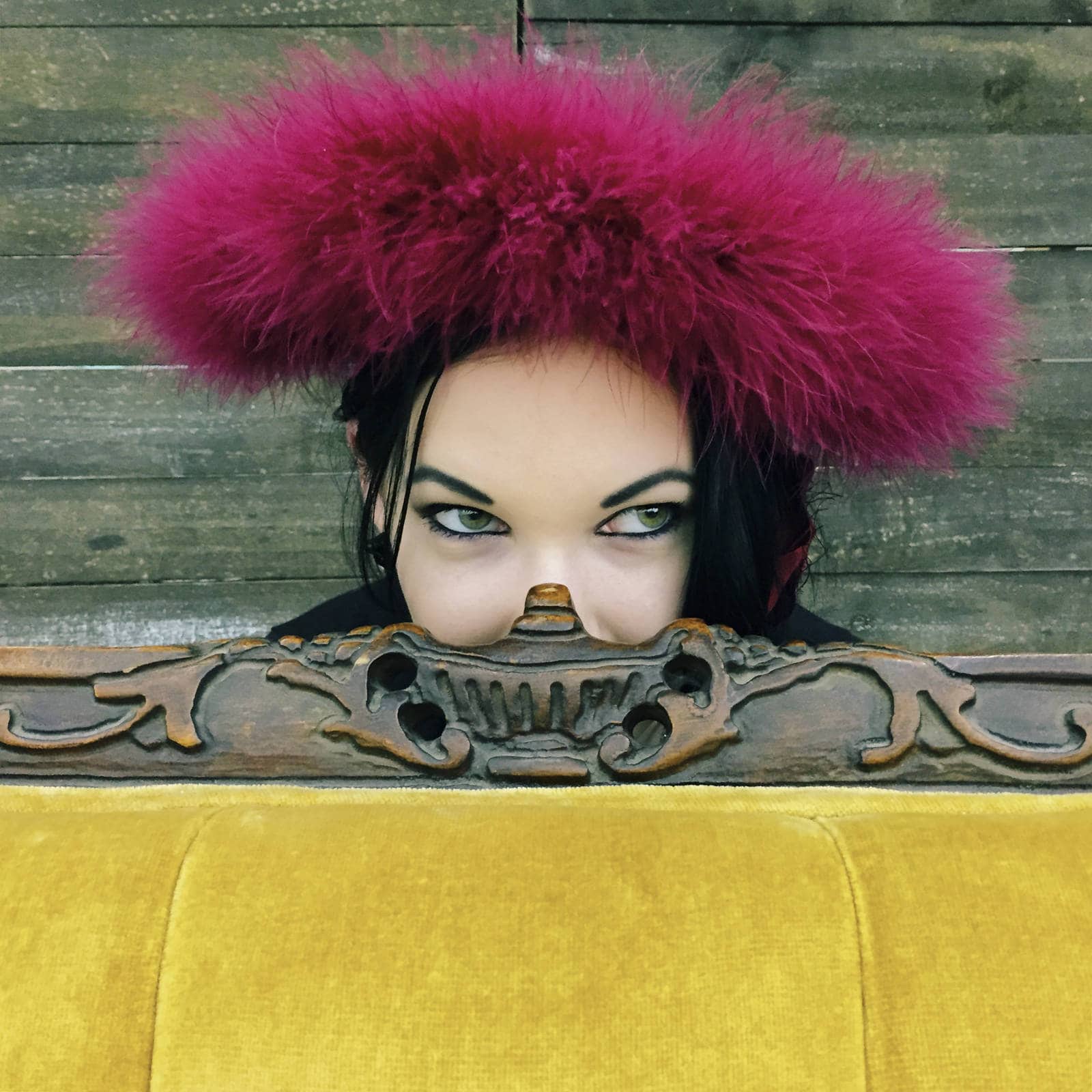 Photos People Remember: Woman peeking from behind a yellow couch