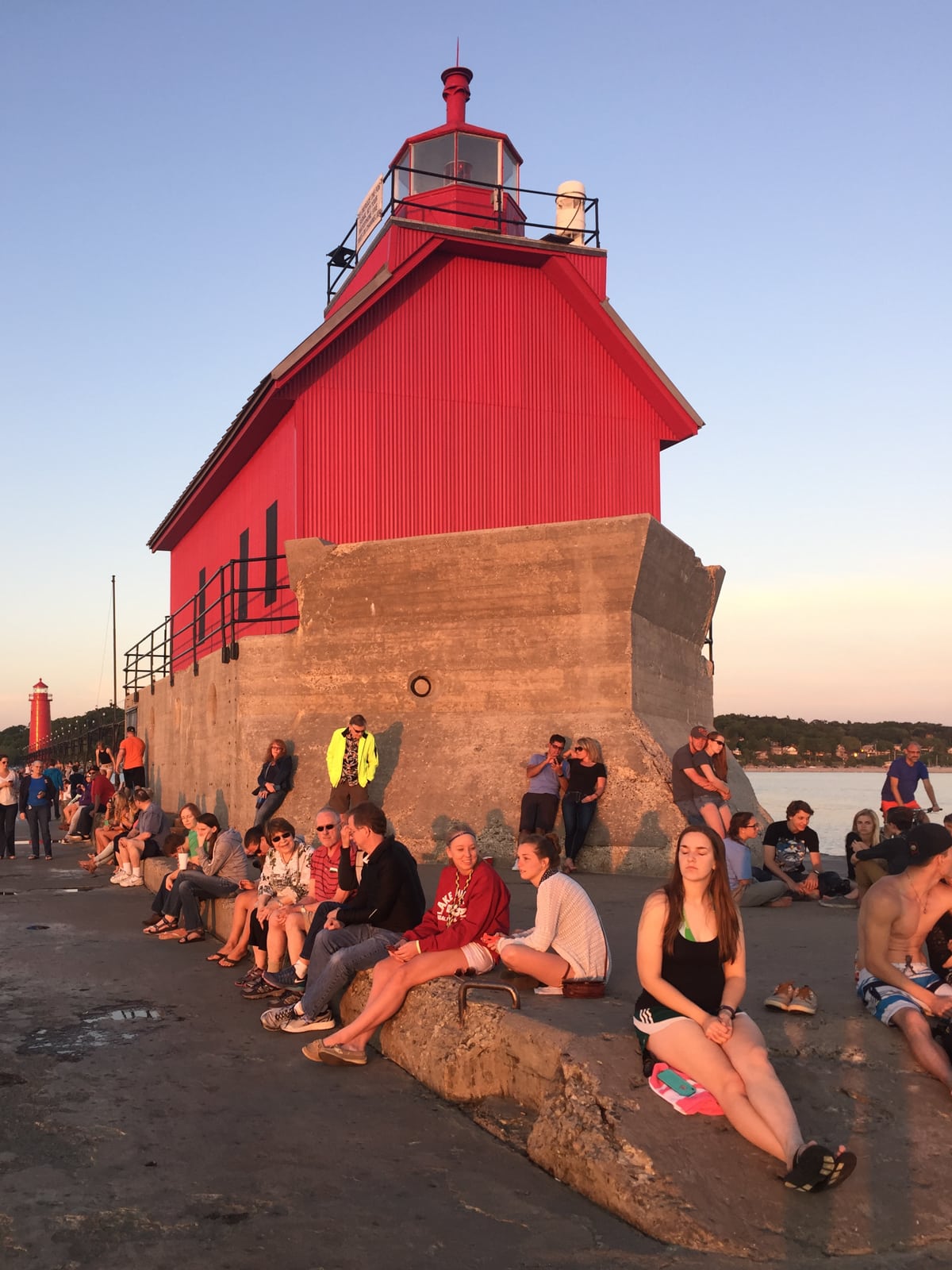 People enjoying the view and weather of on the Grand Haven Lighthouse