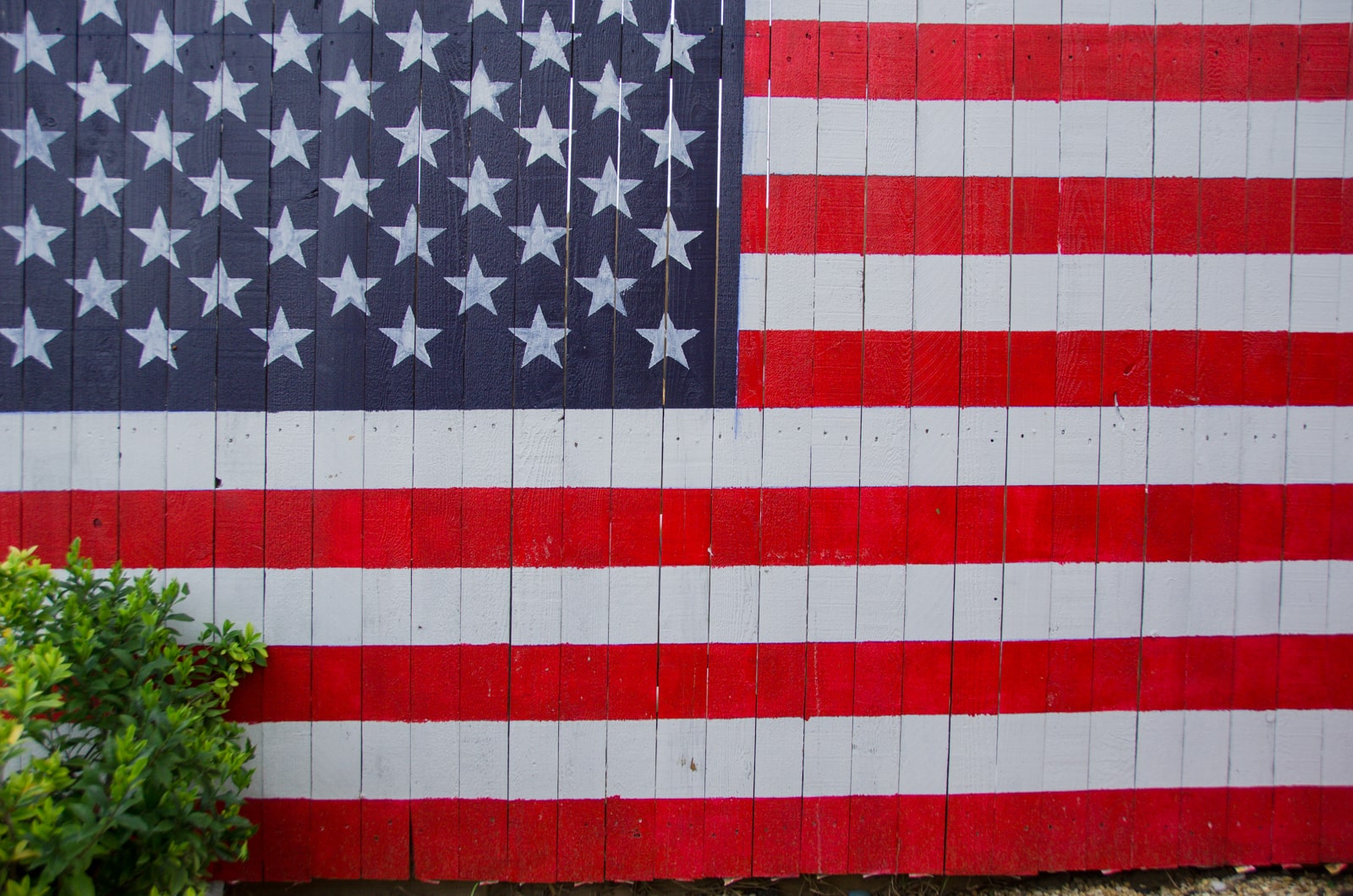 A fence with the American Flag painted on it