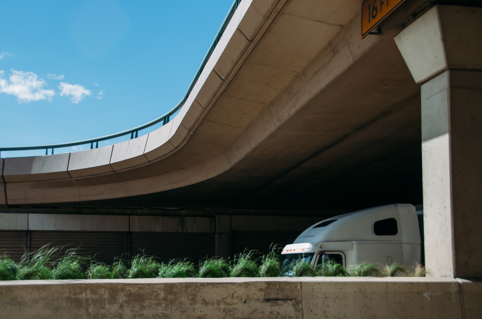 A semi going under a bridge on highway 75