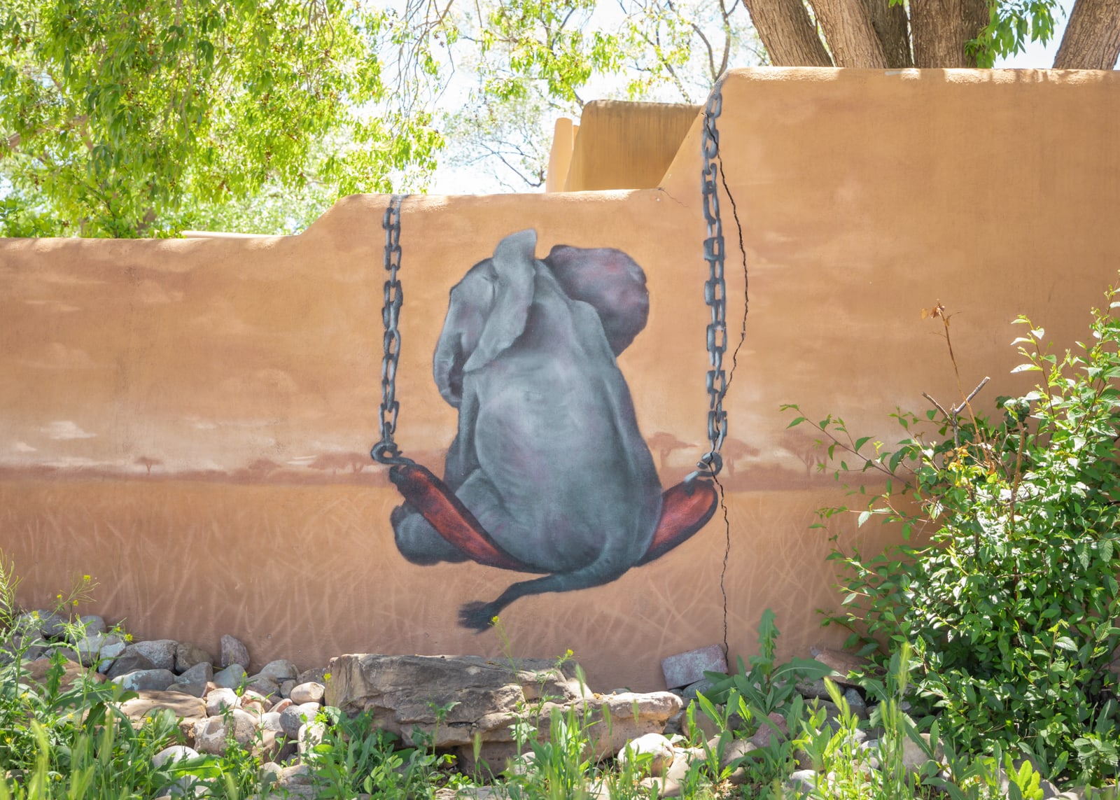 A mural of an elephant on a swing in Santa Fe
