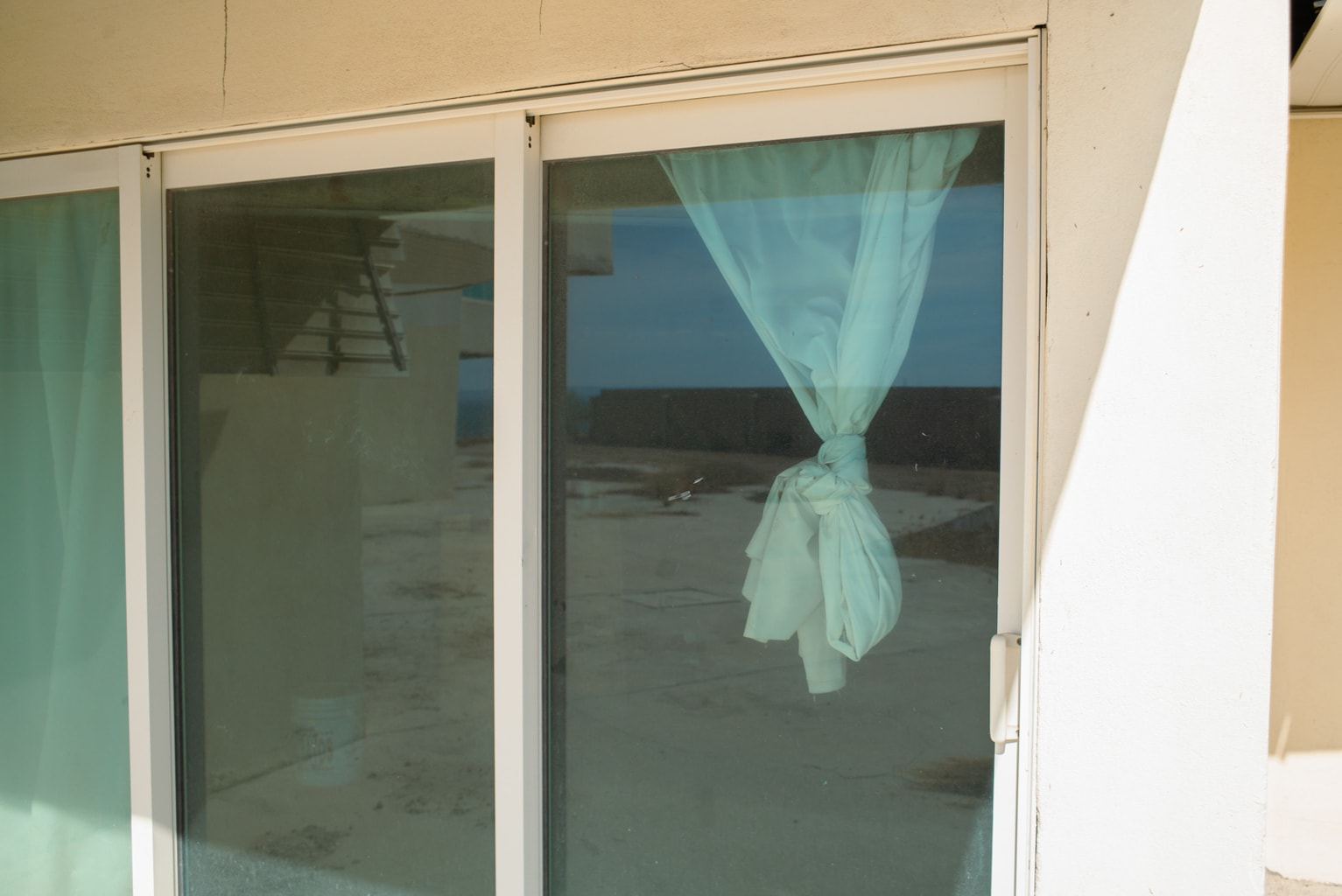 curtains hanging in an empty room at an abandoned Hotel Gran Baja