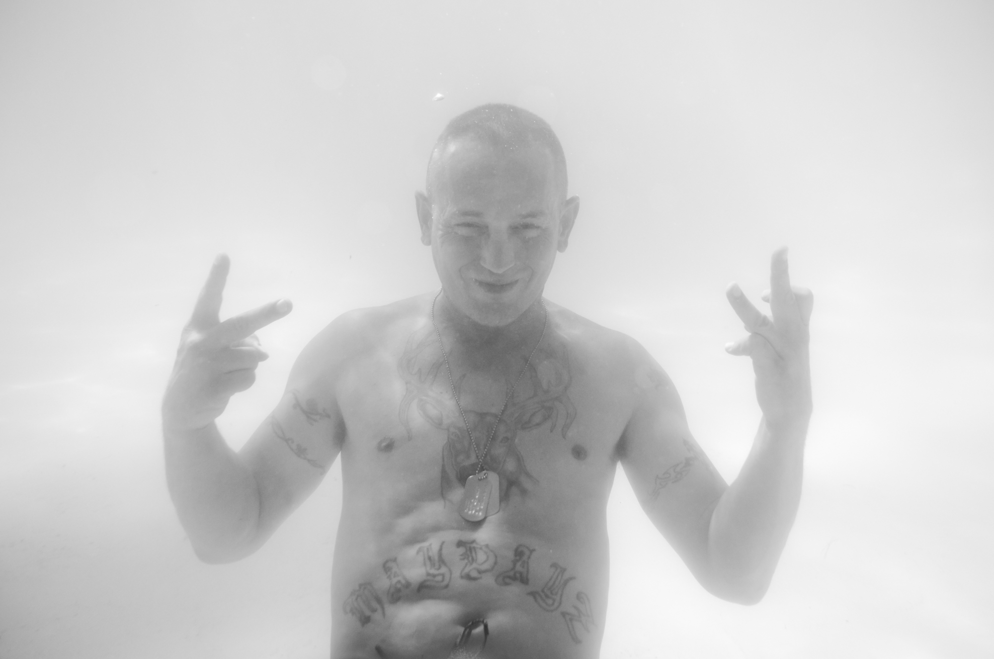 An Underwater Portrait of man with a Madayz tattoo