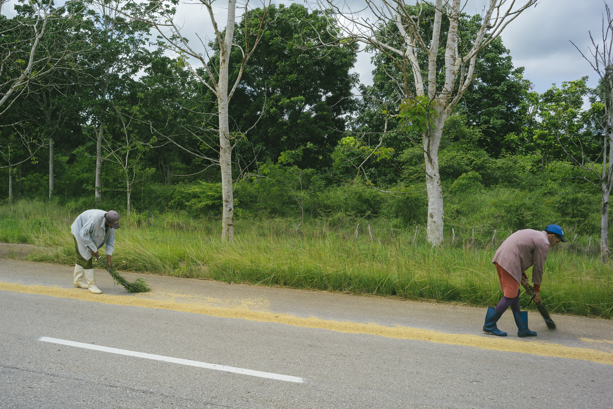 two men trying rice in the street in Antonio De Las Vueltas, Cuba