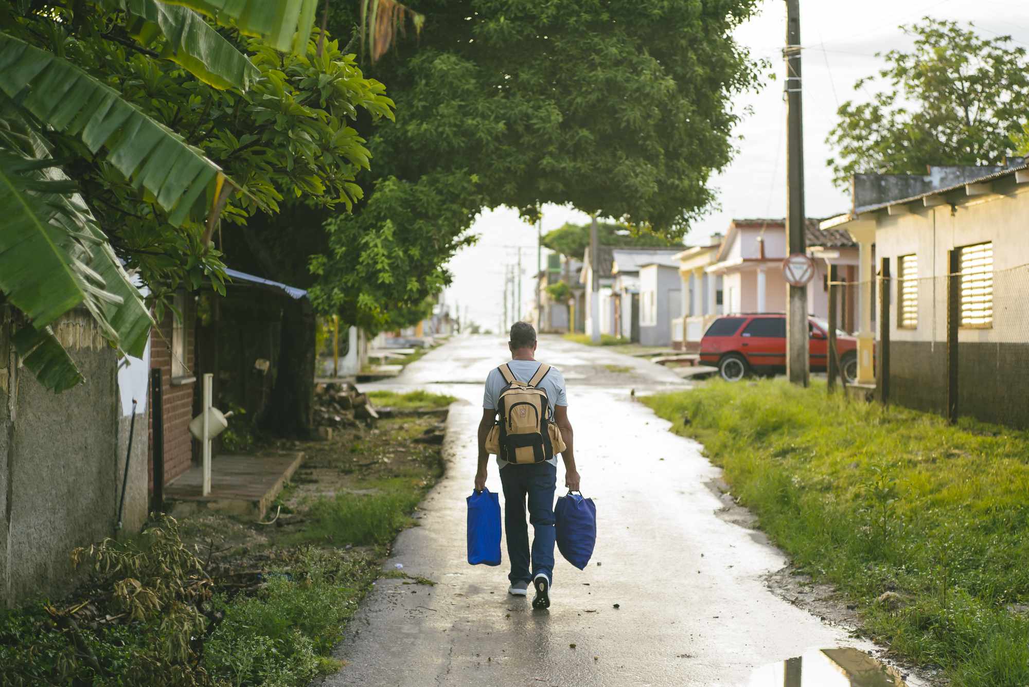 A man carrying groceries in Antonio De Las Vueltas, Cuba