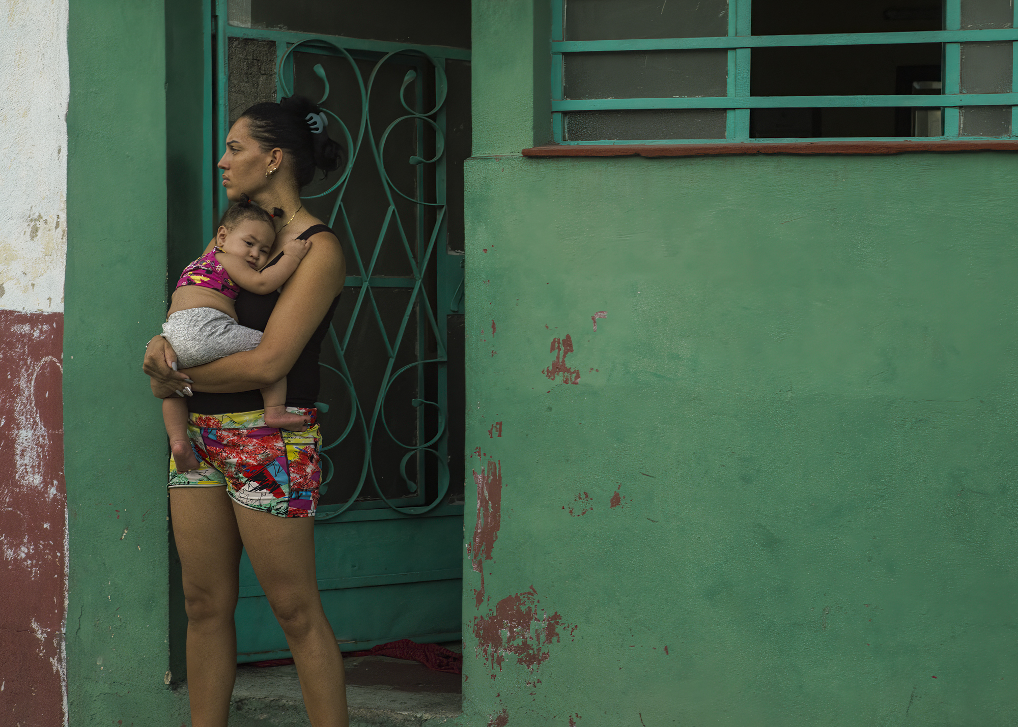 A Cuban woman with her baby in her arms in Havana