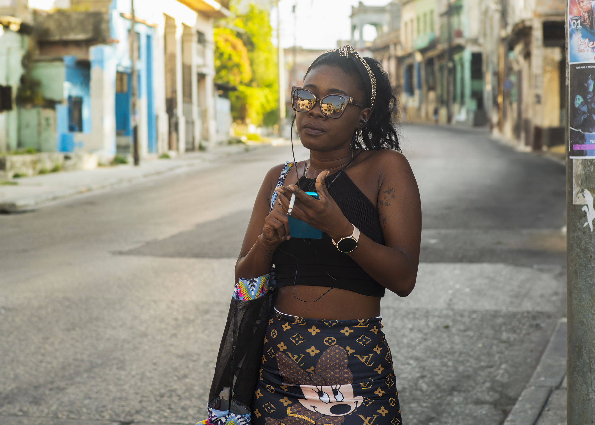 A woman waiting for a taxi in Havana, Cuba
