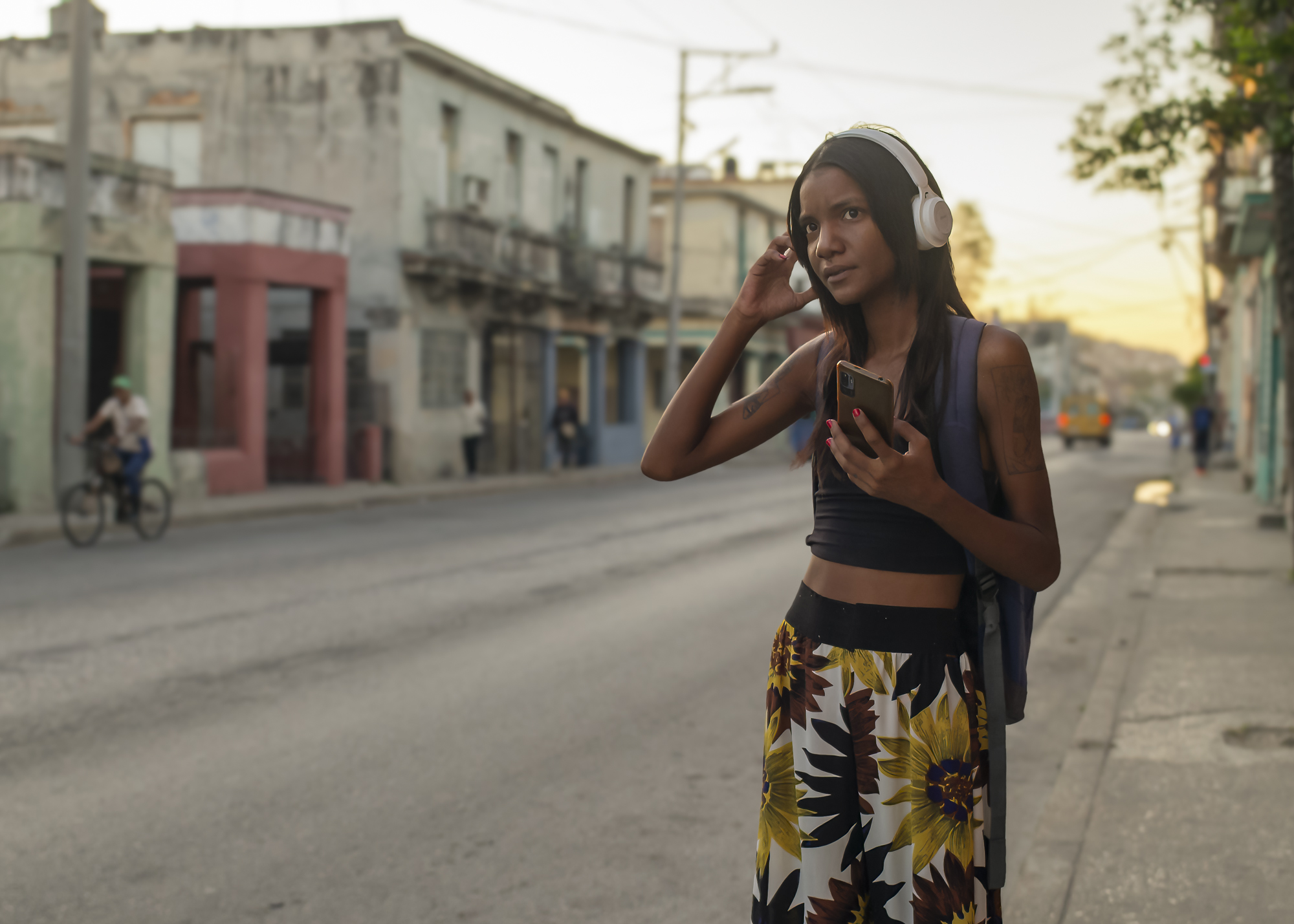 A woman waiting for a taxi in Havana, Cuba